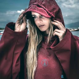 Fourth Element Storm Poncho Lifestyle on Woman - Burgundy Thumbnail}